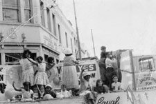 Aboriginal rights activist and community worker Aunty Celia Smith (in hat with back to camera) with Granny Monsell (waving) on May Day float campaigning for a ‘YES’ vote in the 1967 Referendum, Brisbane, 1967.