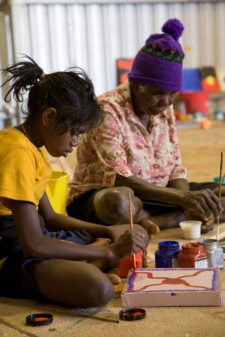 An Indigenous child learning traditional painting at Martumili Arts Centre, 2009