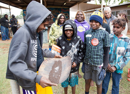 Students learn how to use a yandy — a tool used for surface mining tin