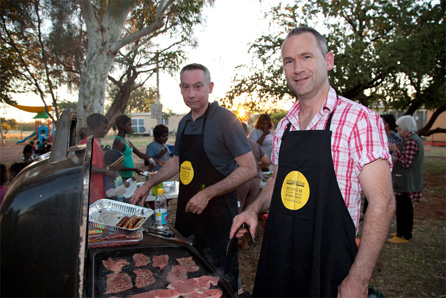 Museum of Australian Democracy Deputy Director Steven Fox and Exhibitions Manager Greg Lissaman cook at the community celebration